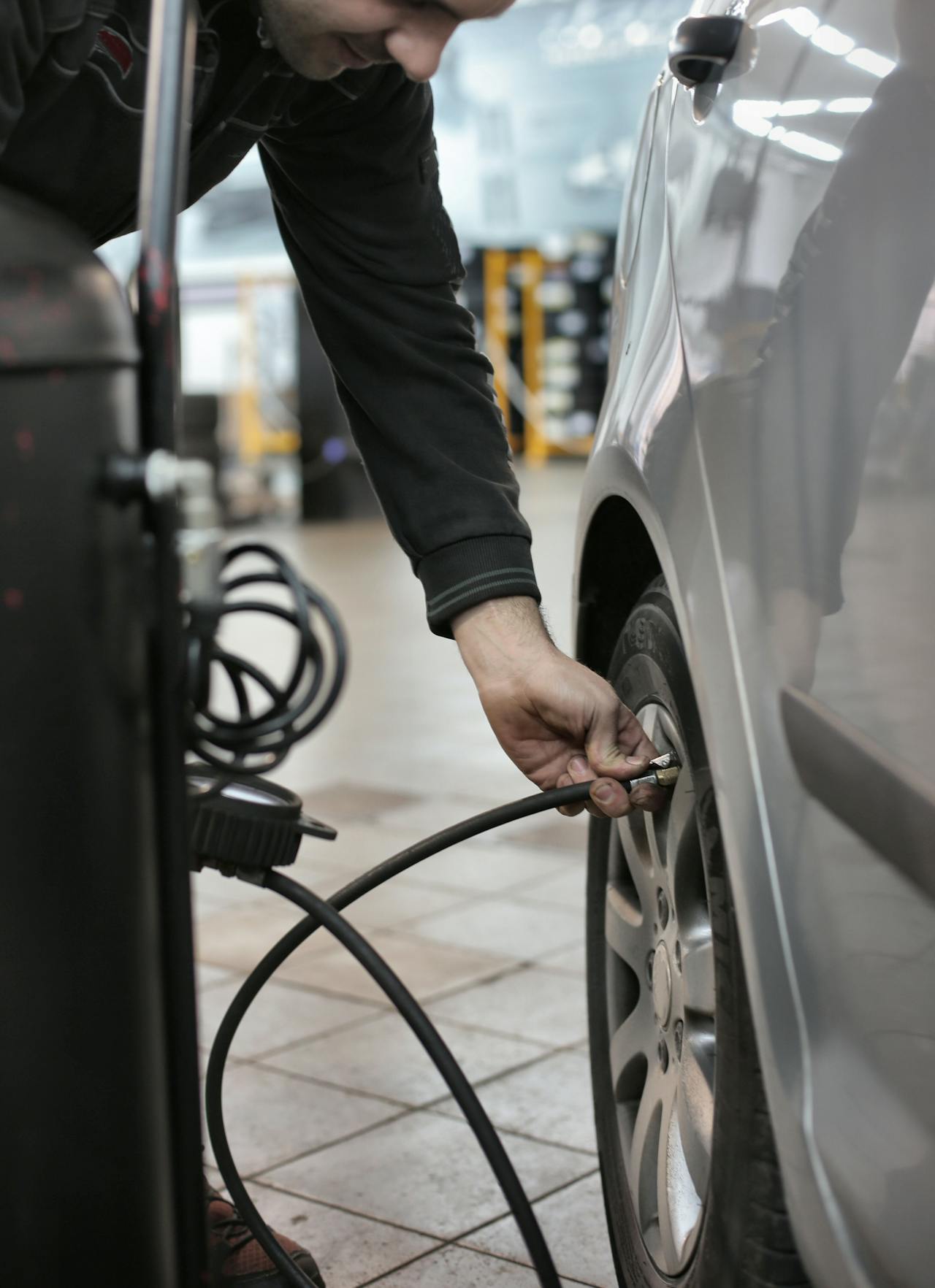 Adding air in short bursts from a compressor or gas-station pump. Stop and re-check with your own gauge often — most station pumps over-fill if you trust their built-in gauge.